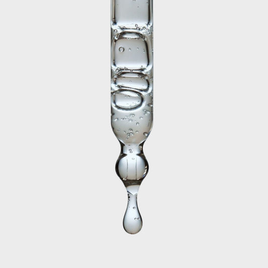 A close-up of a pipette with droplets of hemi squalane