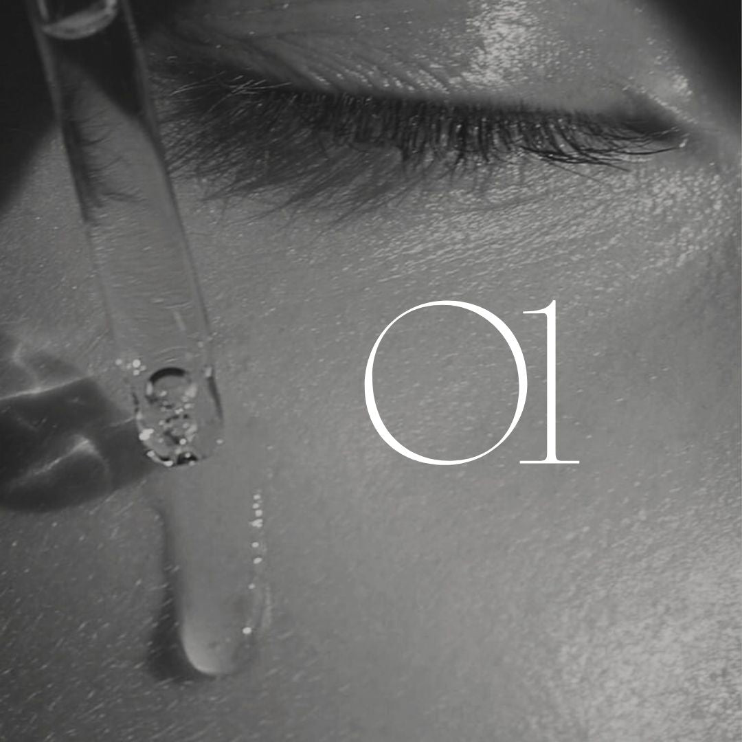 Close-up of a pipette on cheek near eye with number "01". (Black & white image)
