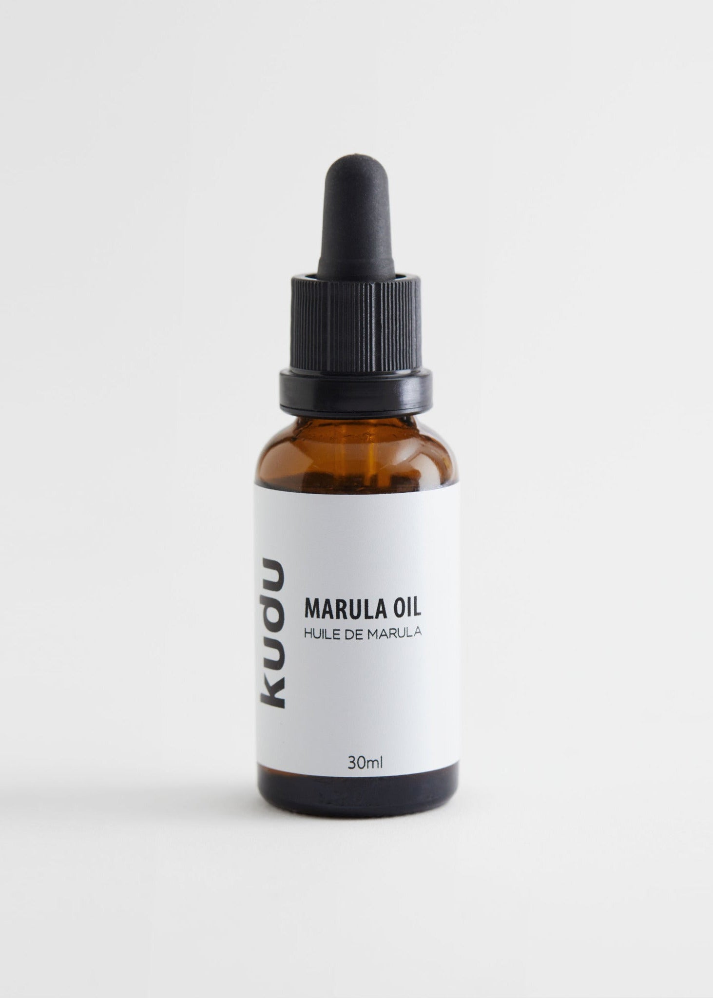 A brown bottle with a dropper cap, labeled Kudu Cosmetica Organic Marula Oil, 30ml," for skincare, rests on a white background. Kudu Cosmetica Organic Marula Oil for Face 