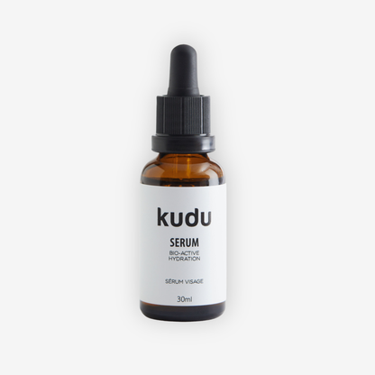 Amber serum bottle with dropper labeled 'kudu' on a white background