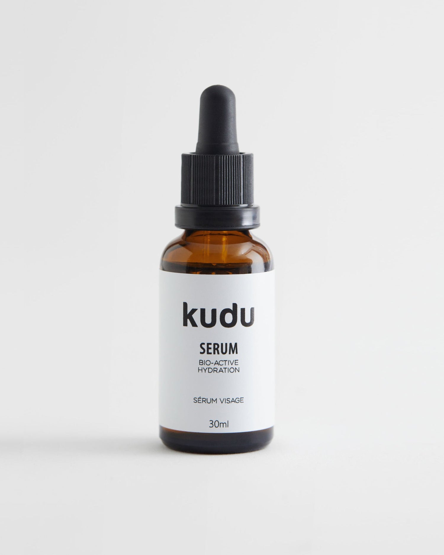 A bottle of face serum on a white background