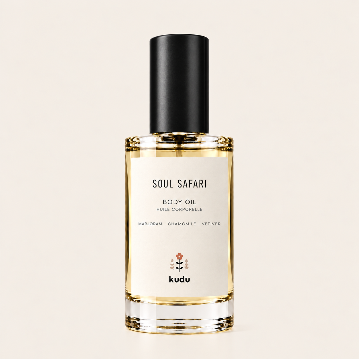 A bottle of Kudu Soul Safari Body Oil with a black cap and a cream-colored label, set against a solid light beige background.