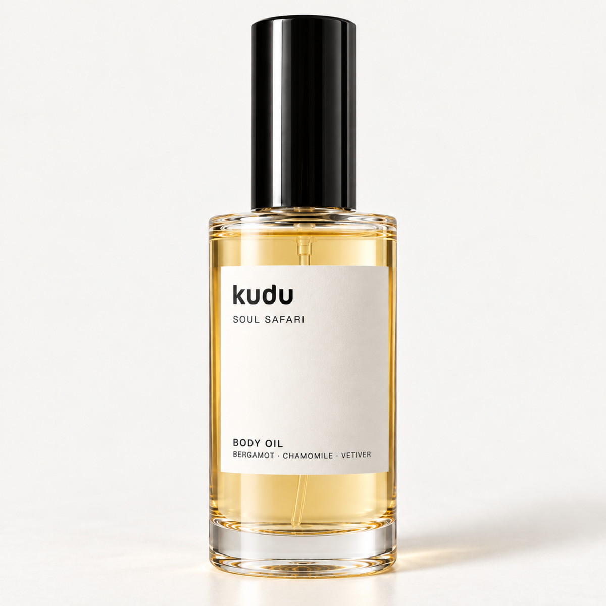 A bottle of Kudu Cabana Rose Body Oil with a black cap and a cream-colored label, set against a solid light beige background.