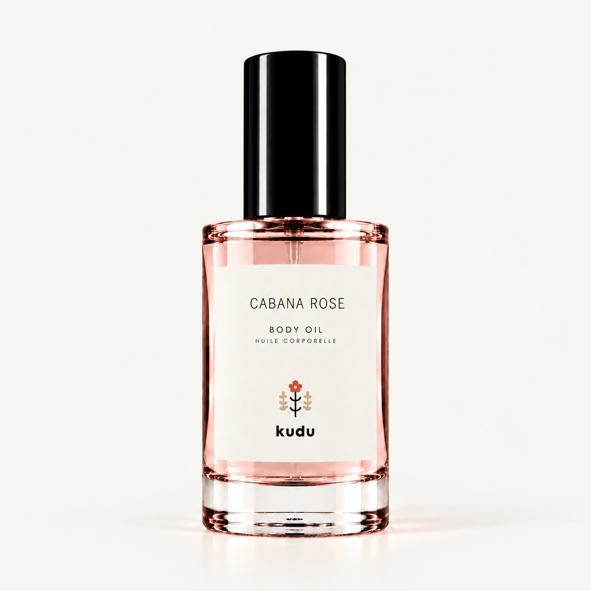 A bottle of Kudu Cabana Rose Body Oil on a clean white background. The clear glass bottle shows the pink rose-colored oil inside, with a white label and a black cap.