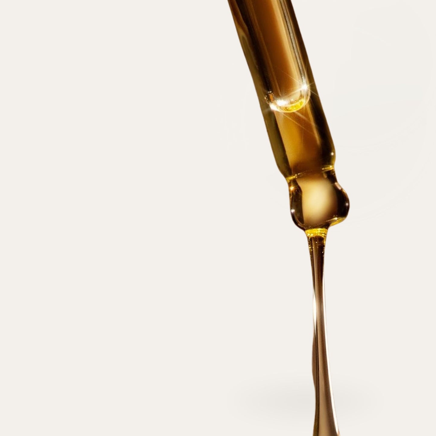 Close-up of Kudu Cosmetica facial serum dropper with hydrating botanical oil on a white background
